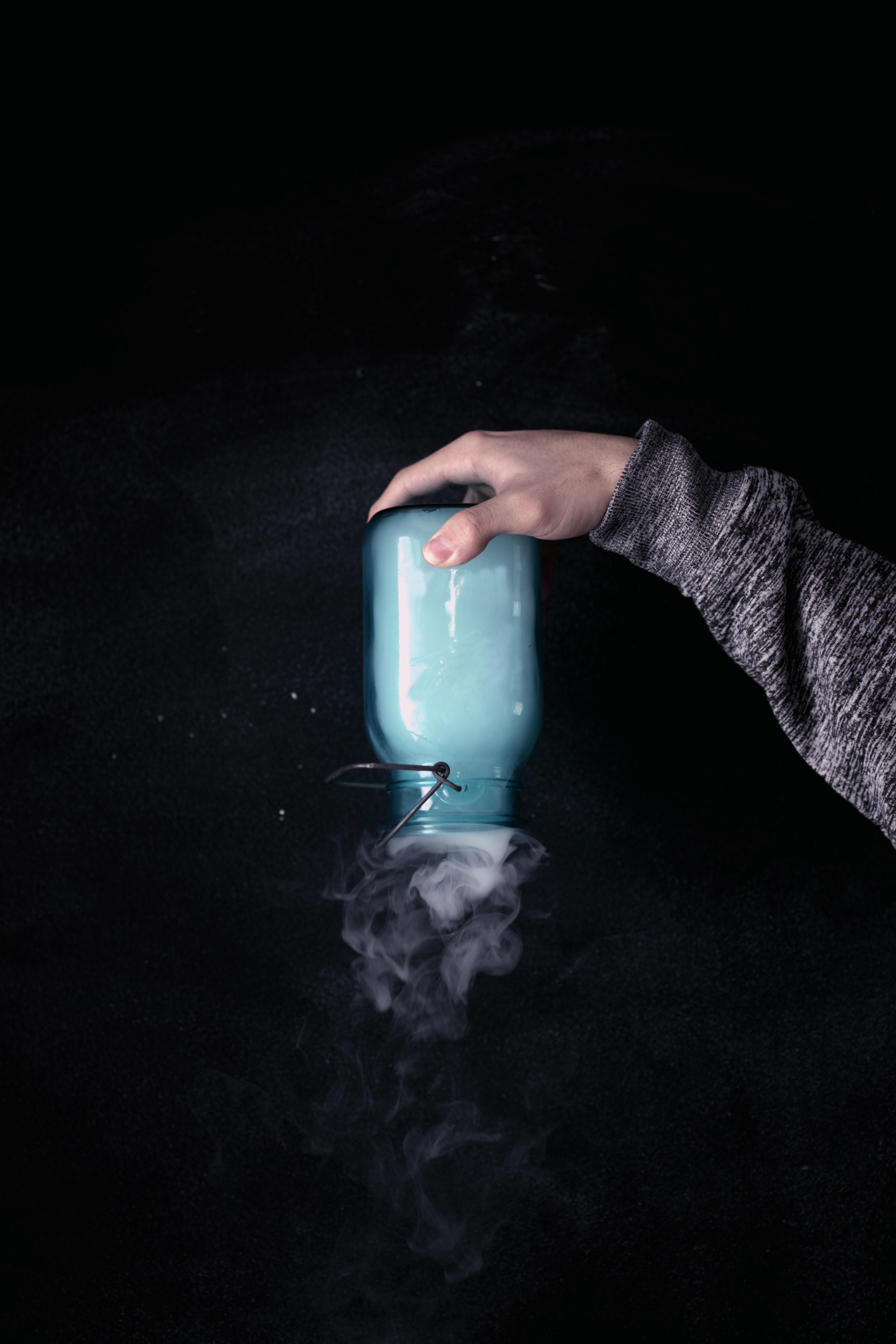 Hand holding upside down potion jar