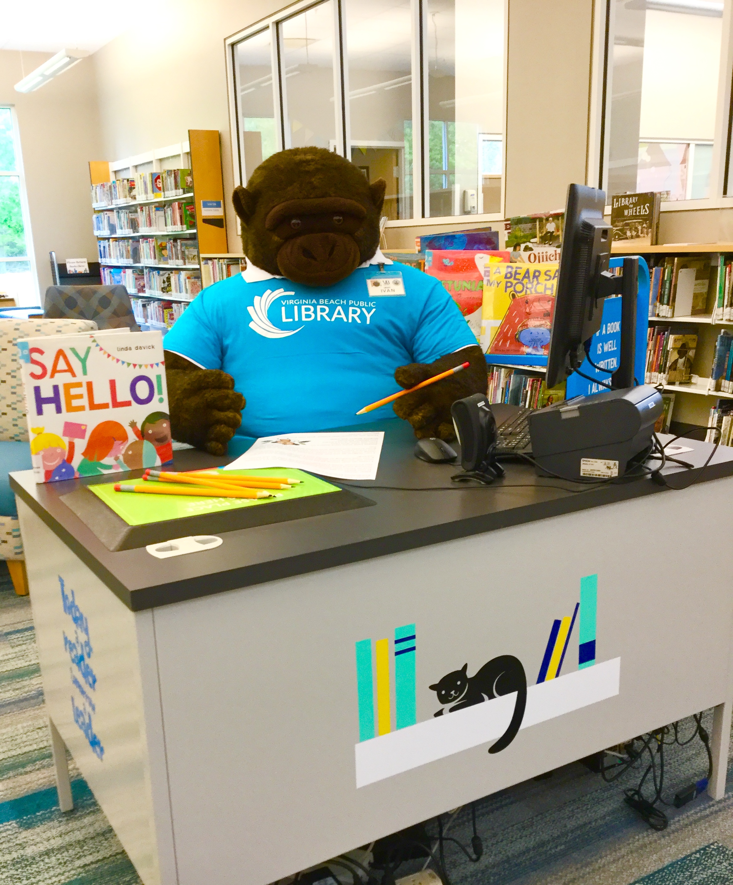 Ivan the gorilla sitting at the Children's Desk at the Princess Anne Library ready to write a letter.