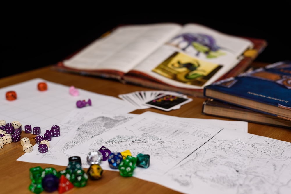 Role-playing books, papers, and dice on a table.