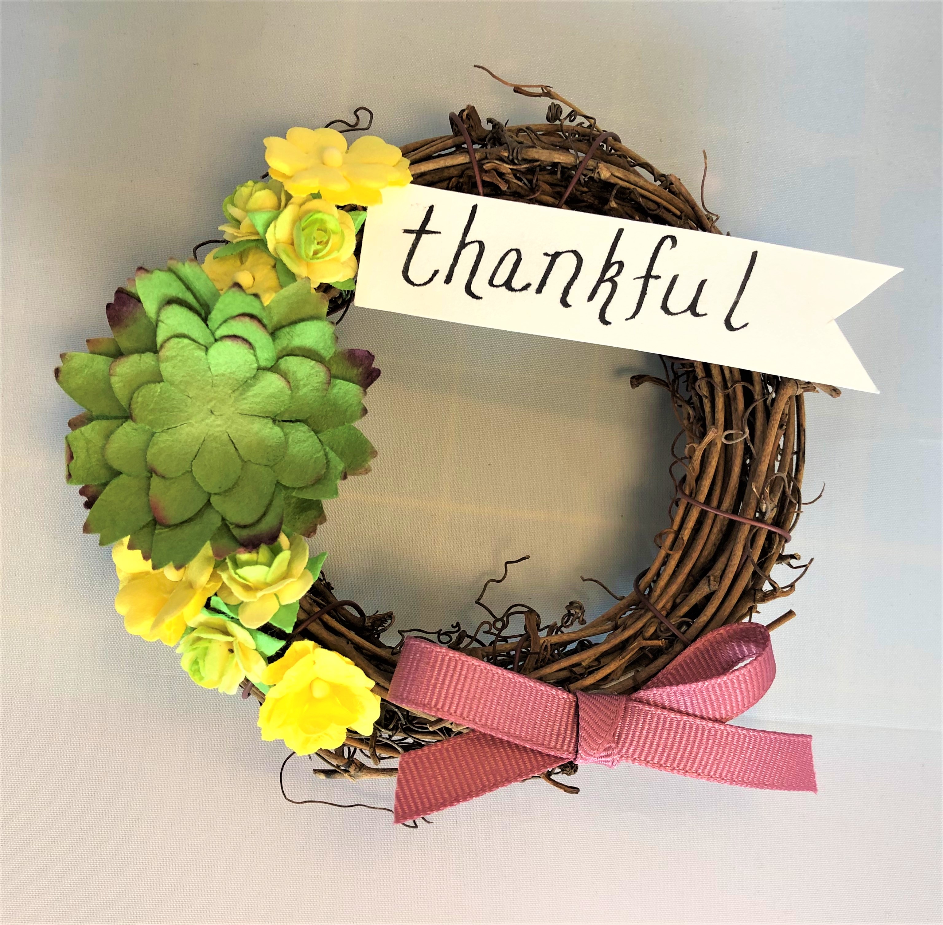 Mini Grapevine Wreath with paper flowers, a bow at the bottom, and a paper flag with the word thankful at the top