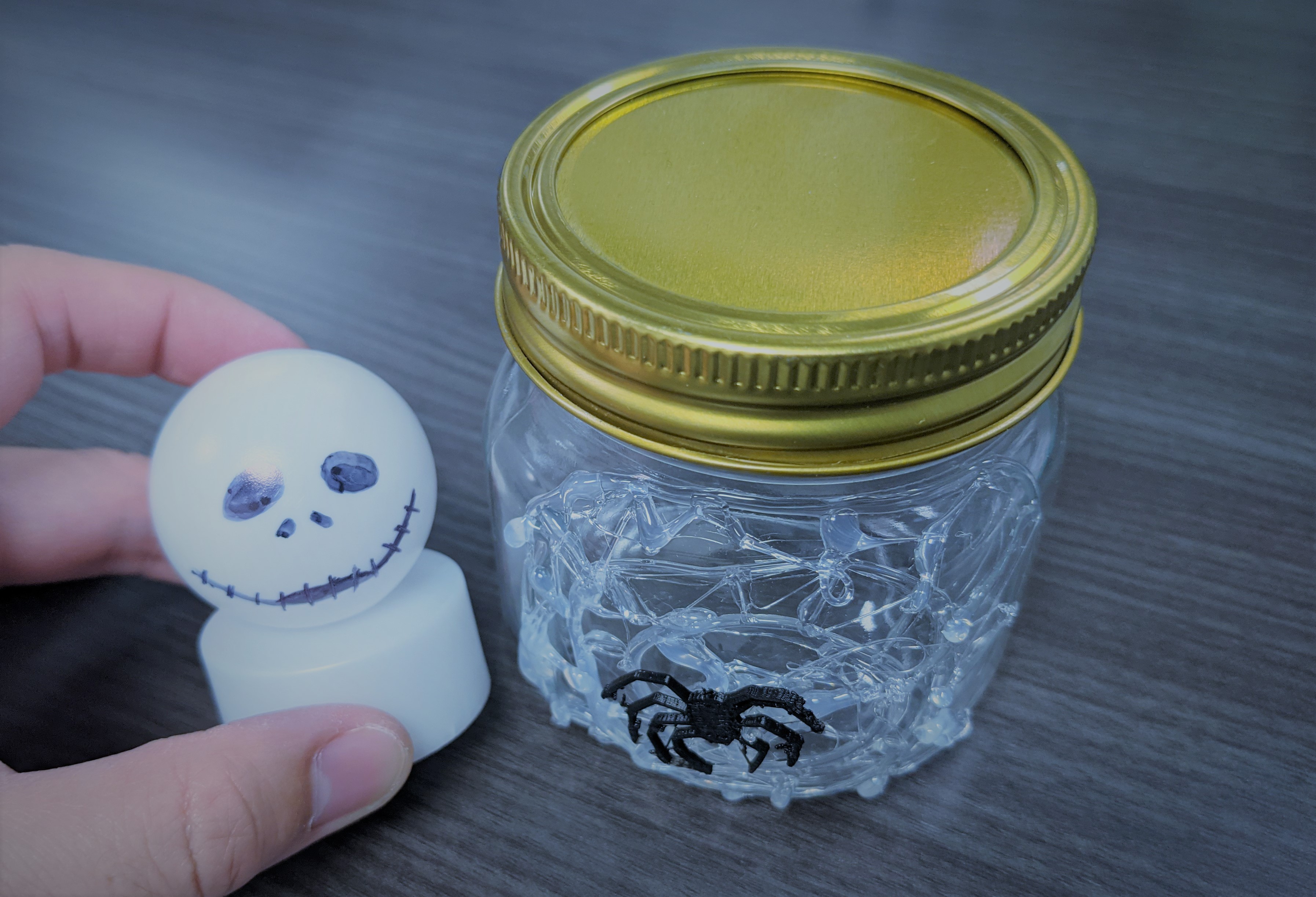 Jack Skellington face on Ping Pong ball and mason jar with web and spider