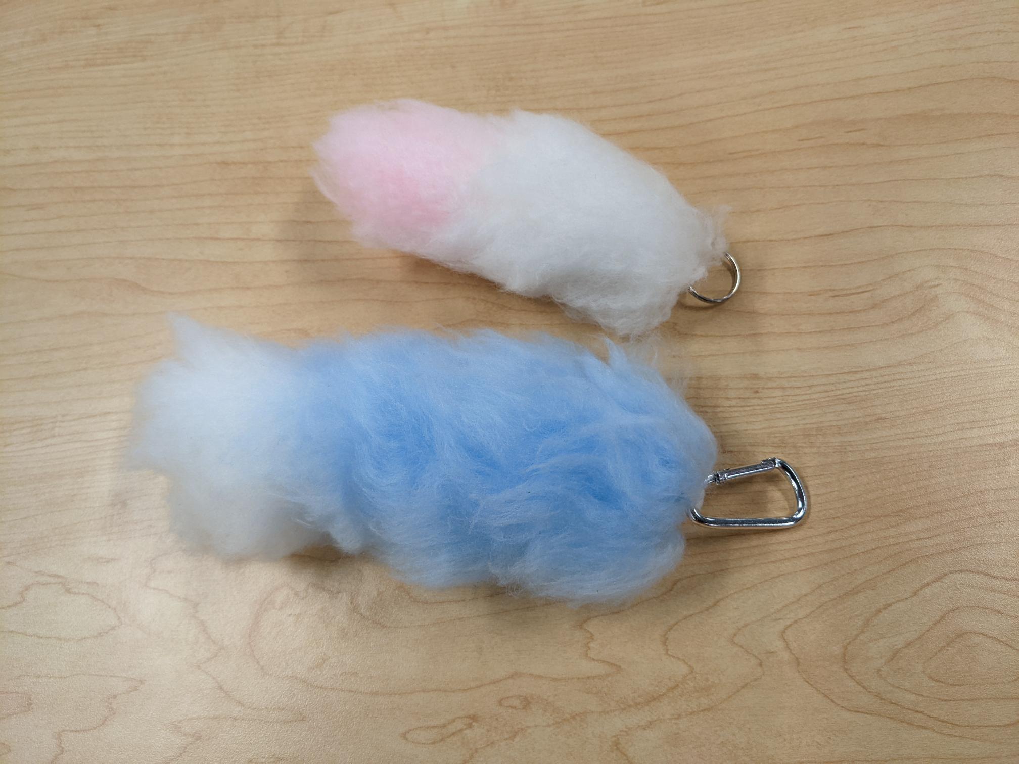 pink and white foxtail keychain and white and blue foxtail keychain
