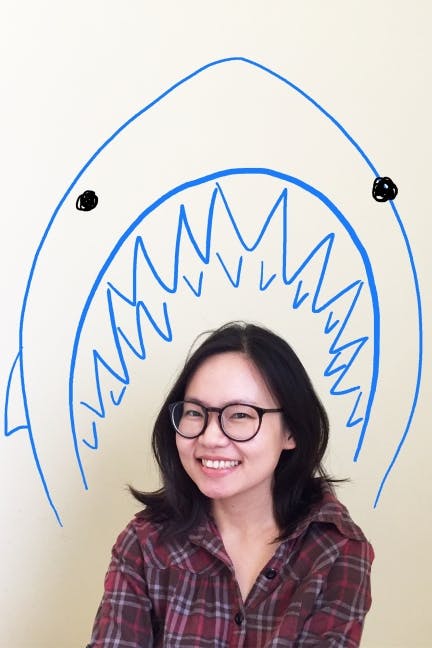 Illustrated shark behind author Remy Lai's photograph 