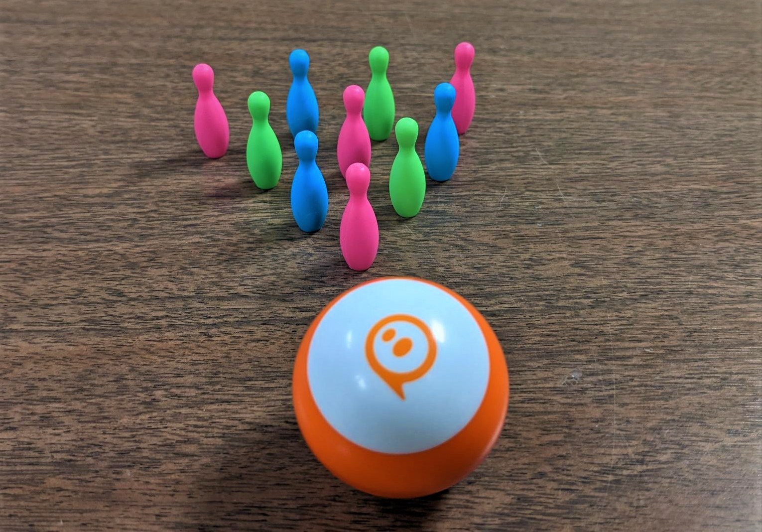 orange Sphero Mini with 10 mini bowling pins
