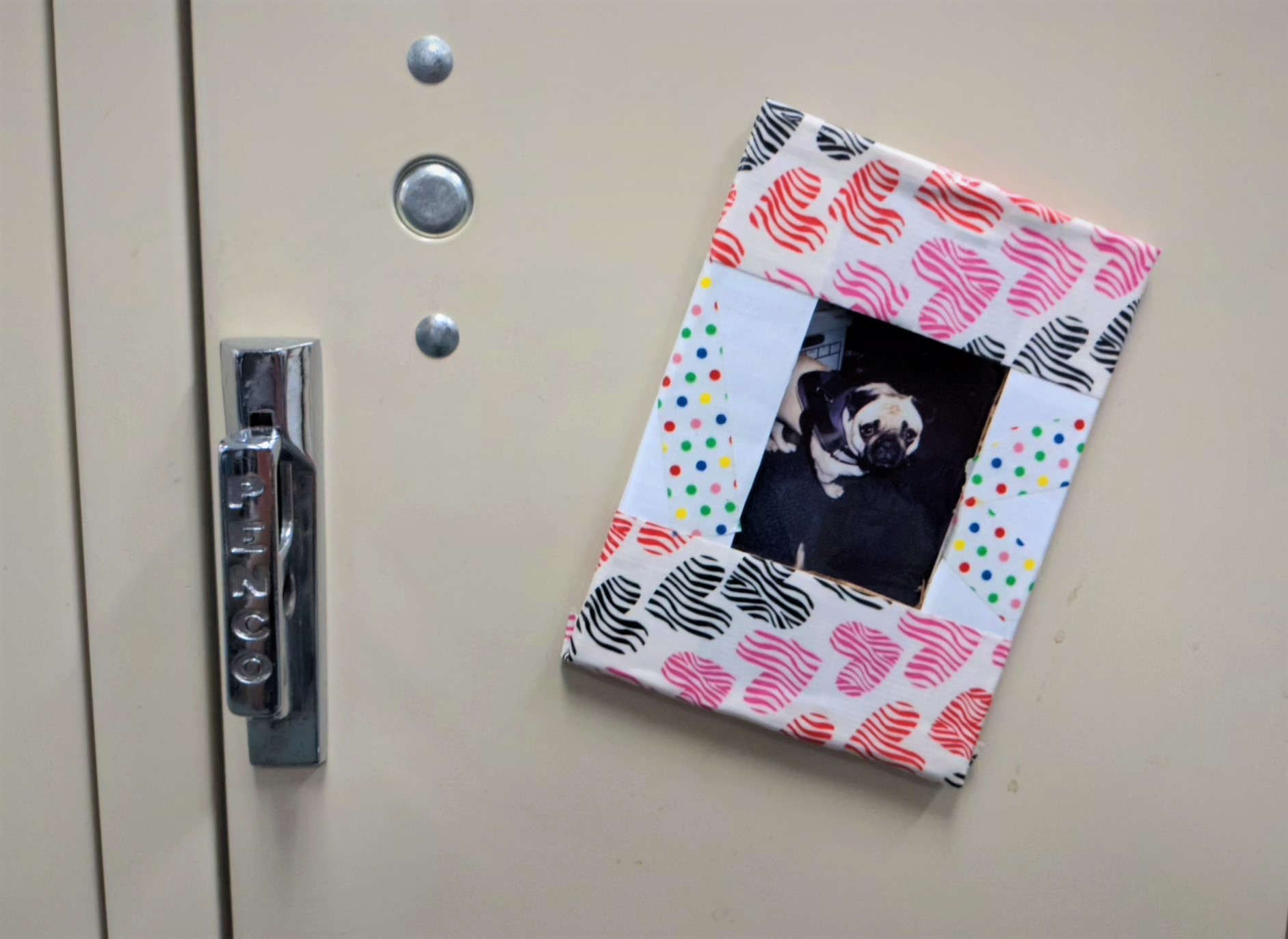 heart pattern and white duct tape photo frame of pug on a locker