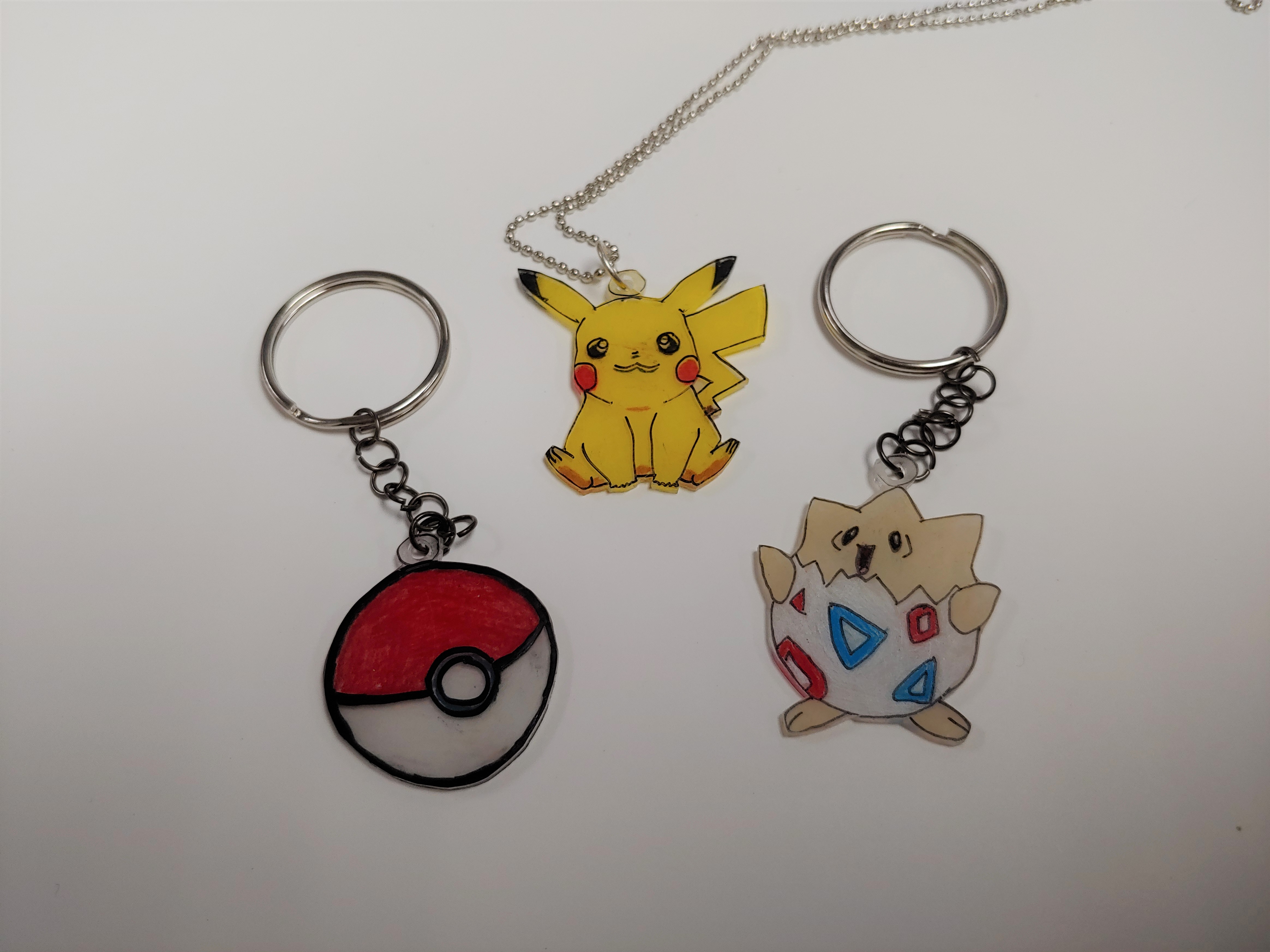 Shrinky Dink keychain and necklace of Pokeball, Pikachu, and Togepi