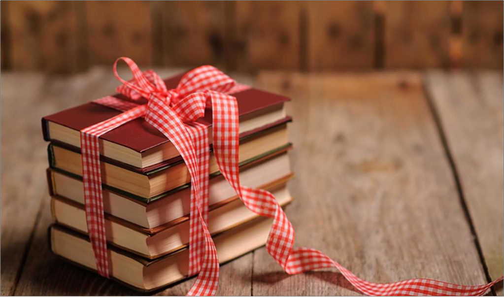 Stack of red books tied with a red ribbon like a gift to be unwrapped