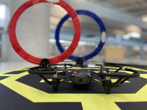 Two circular obstacles and a drone on a yellow and black surface