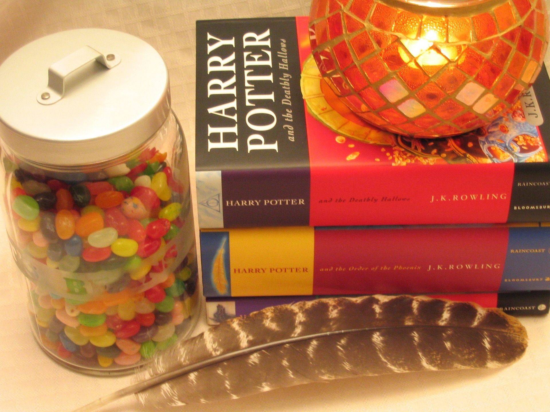 Harry Potter books, a feather, candy jar, and other container