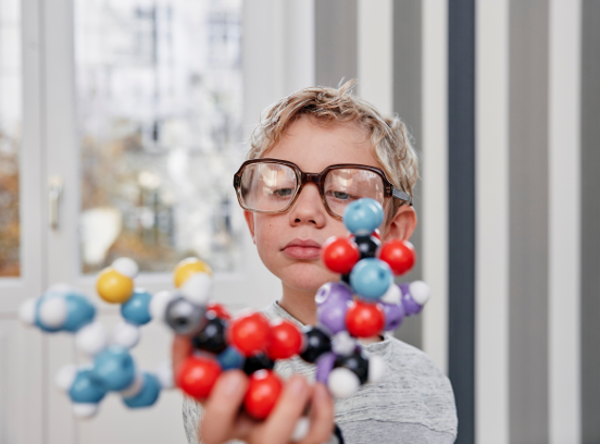 Young scientist with molecule model.
