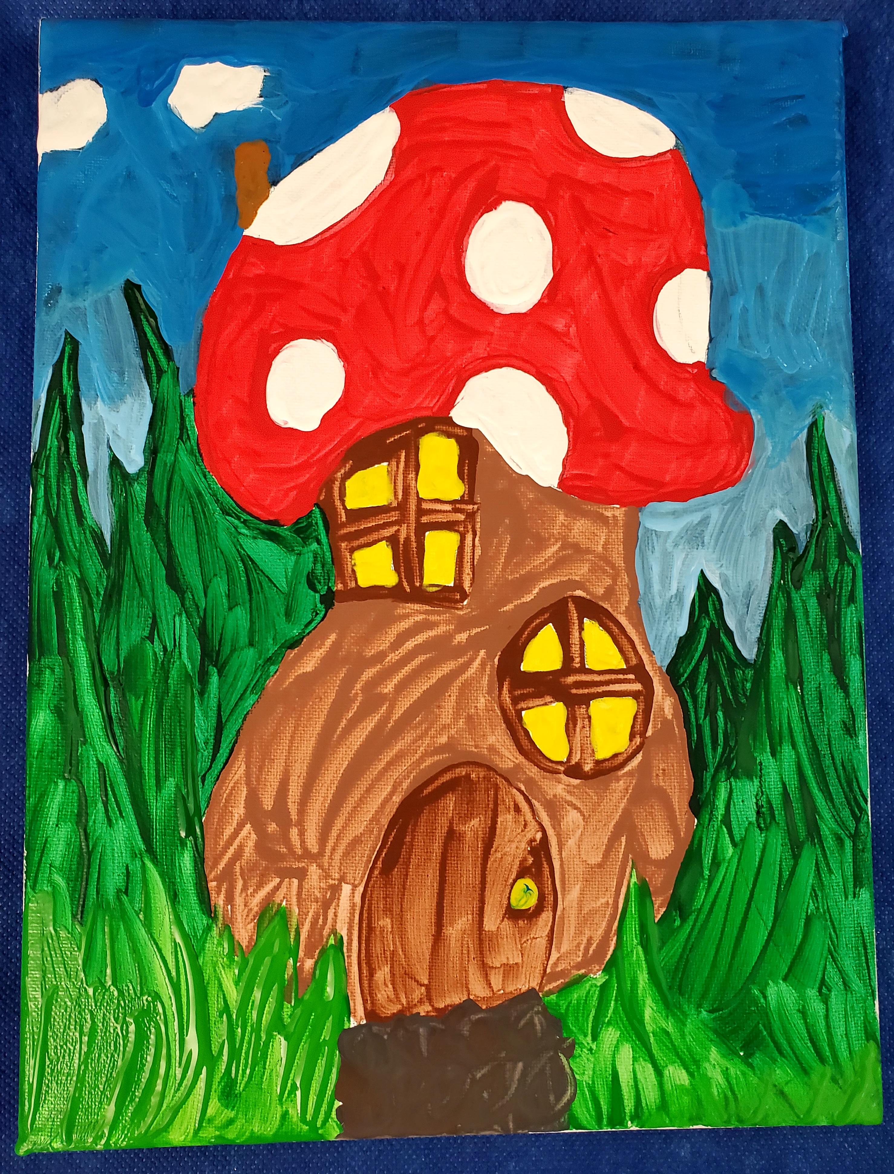 A mushroom house with a red roof with white spots, a brown chimney with white puffs of smoke coming out of it, and a brown mushroom base with two windows with light shining and a door with a yellow doorknob. The house is surrounded by different shades of blue sky and various shades of green grass.