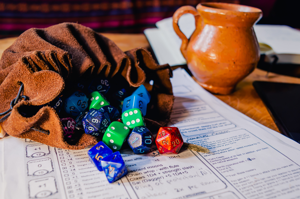 roleplaying dice of various shapes and colors spilling out of a leather dice bag on a character sheet