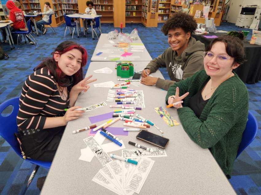 Group of teens working on bookmarks.