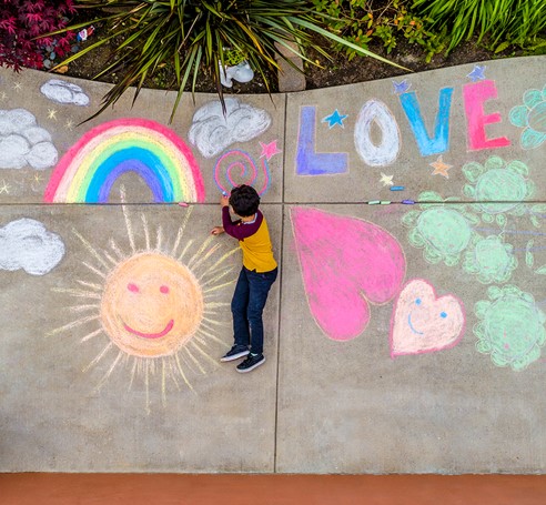 Child and sidewalk chalk