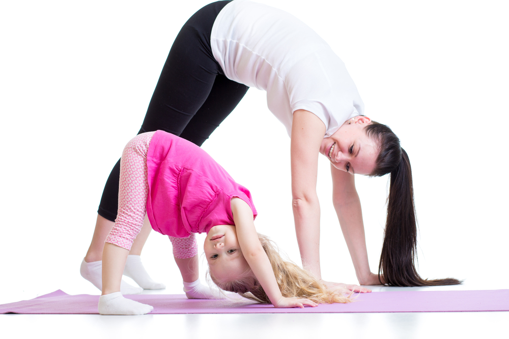 Parent and child doing yoga together