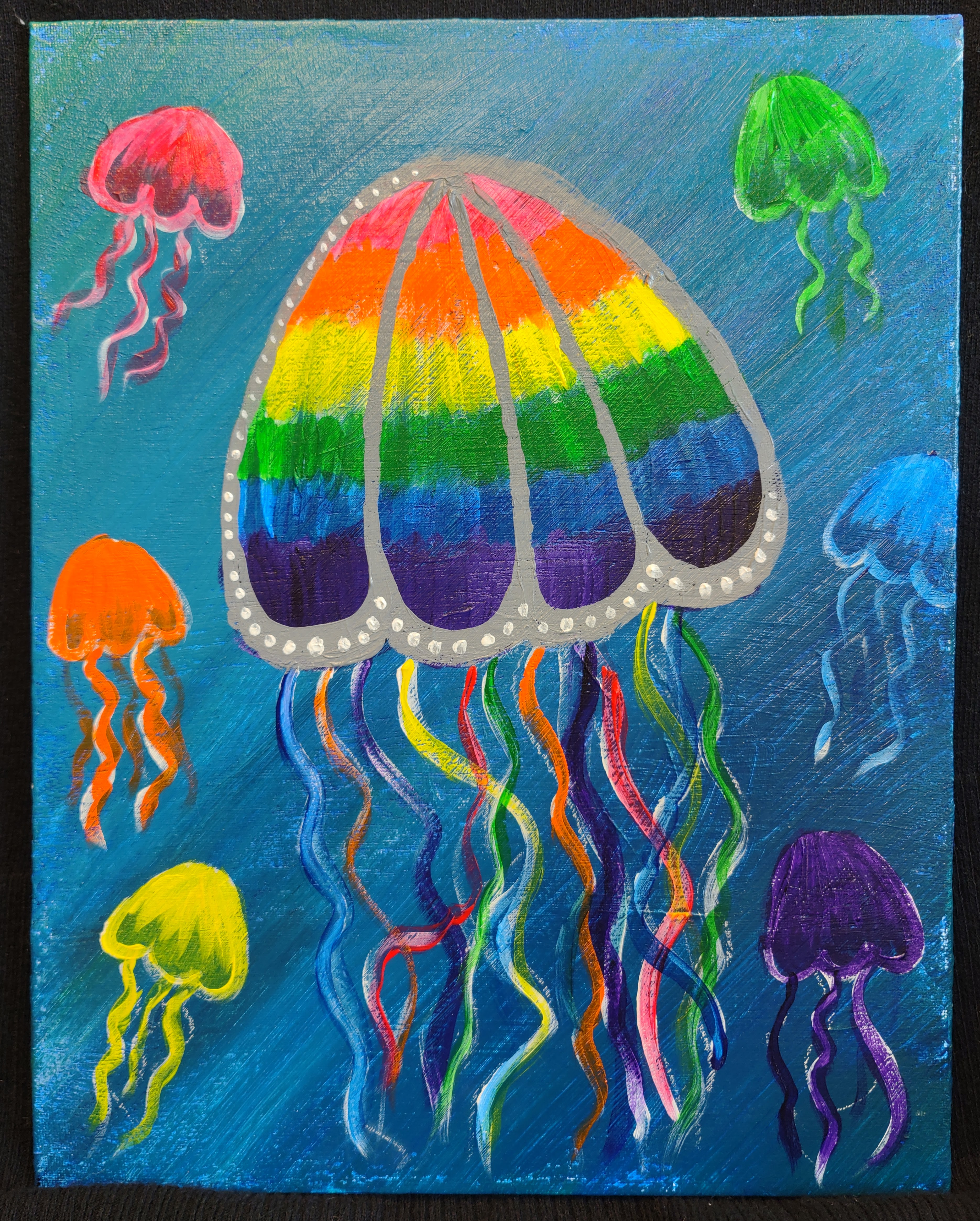 A large rainbow jellyfish is painted over a blue/green background. There are six smaller jellyfish that are red, orange, yellow, green, blue, and purple.