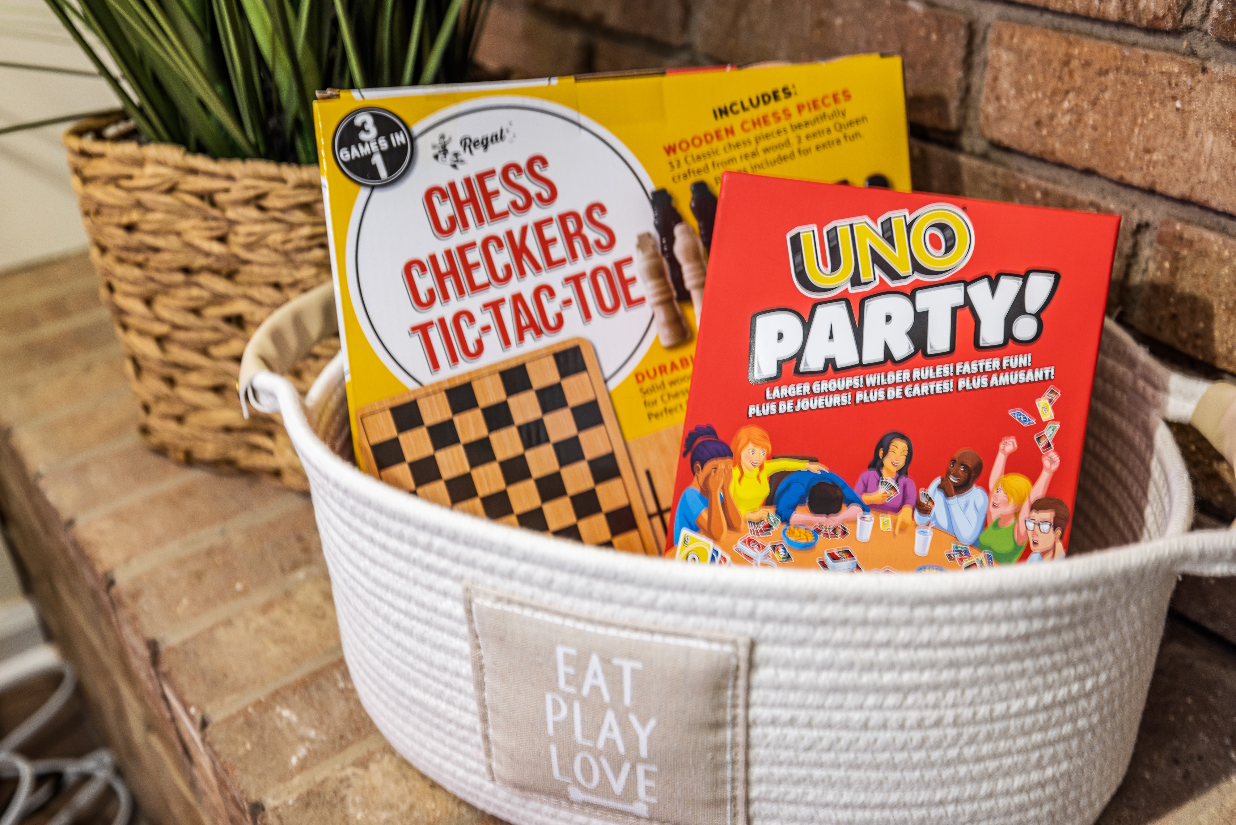 basket holding Checkers and Chess board and UNO