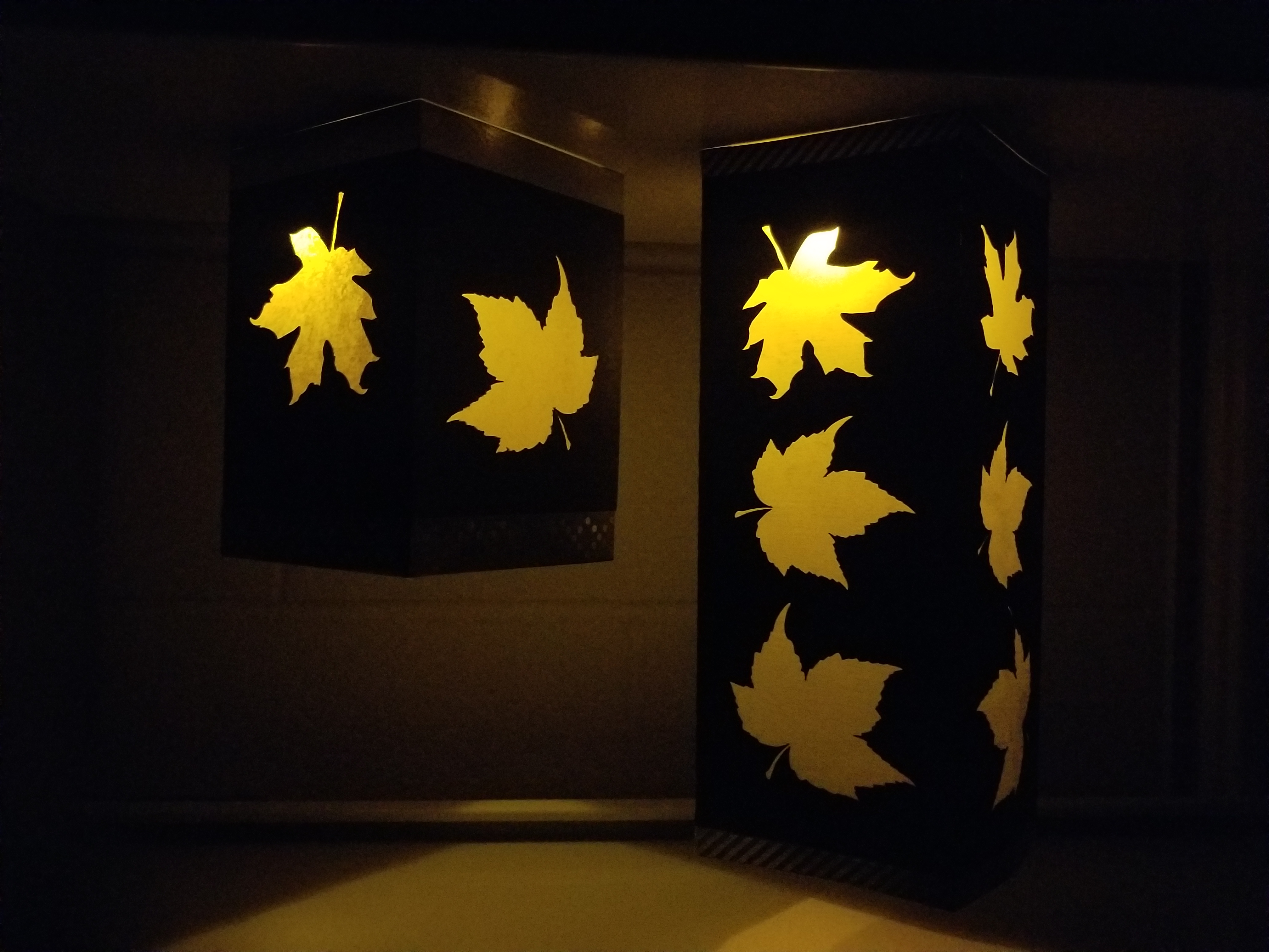 2 paper luminaries lit up with tealights