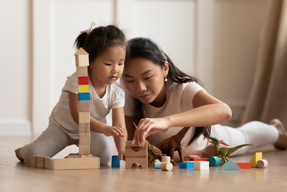 A mother and daughter playing with blocks 