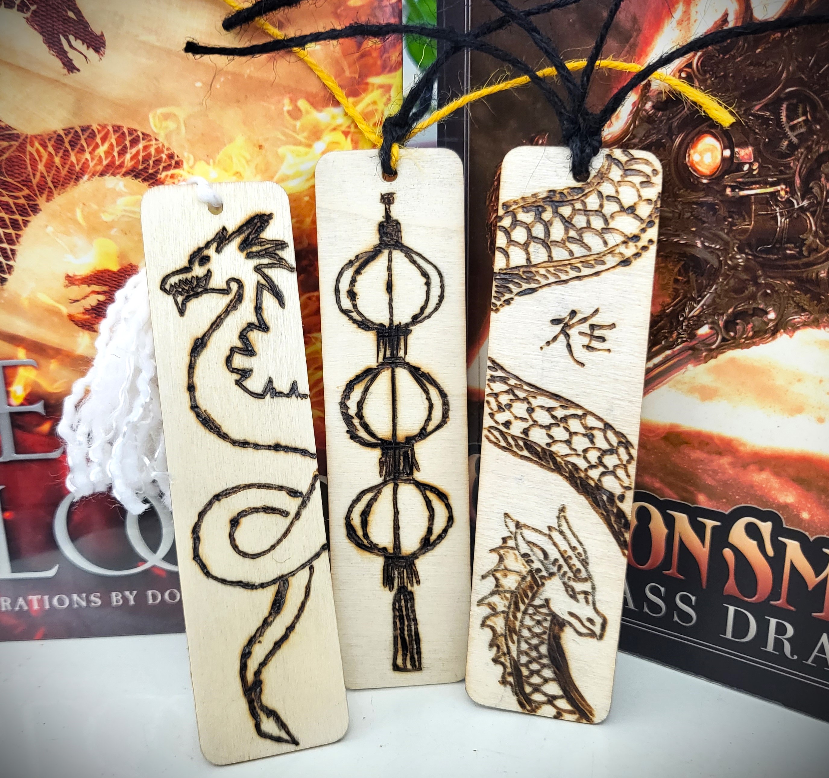 Image of woodburned bookmarks with images of dragons and lanterns