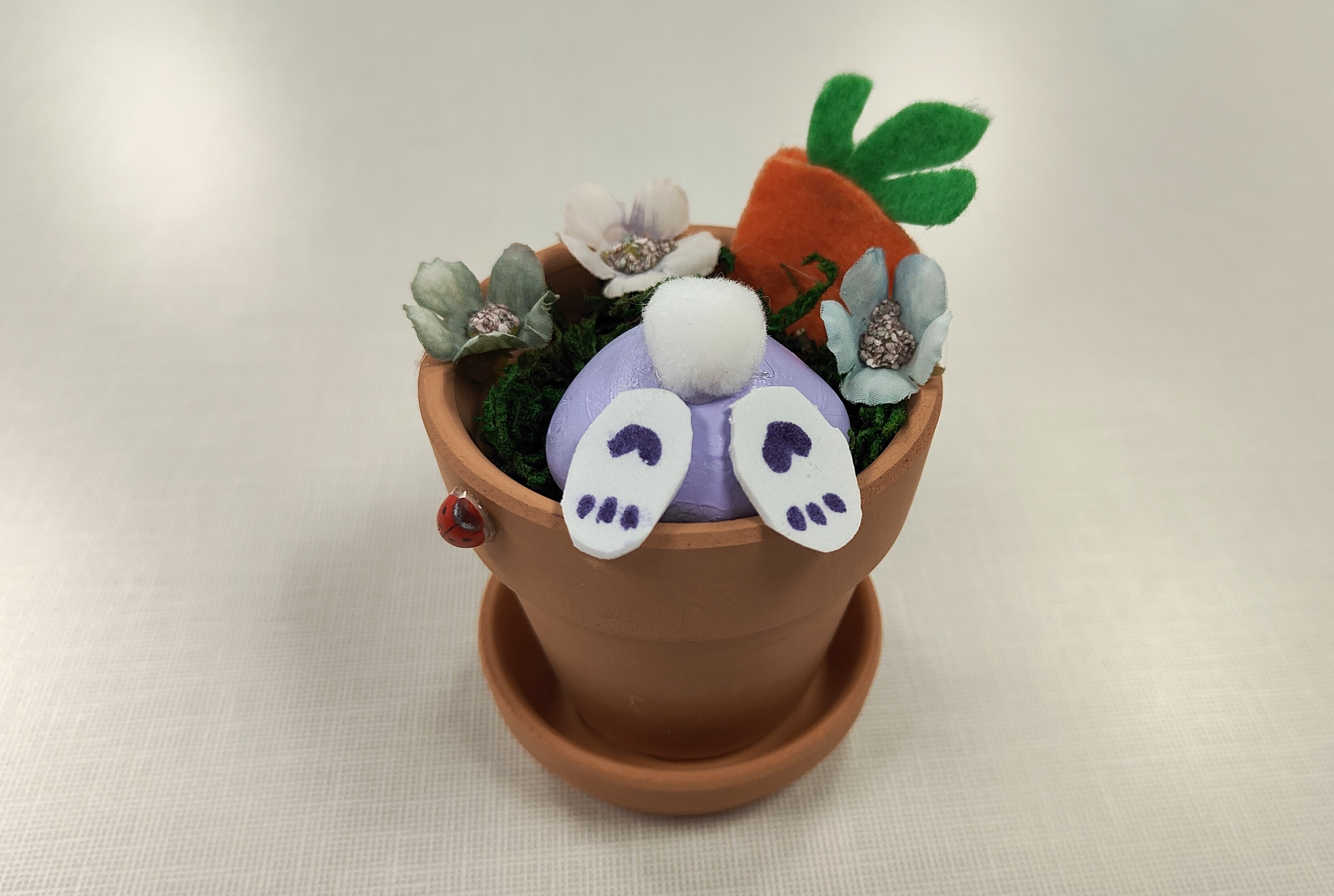 clay pot with a bunny, flowers, and felt carrot