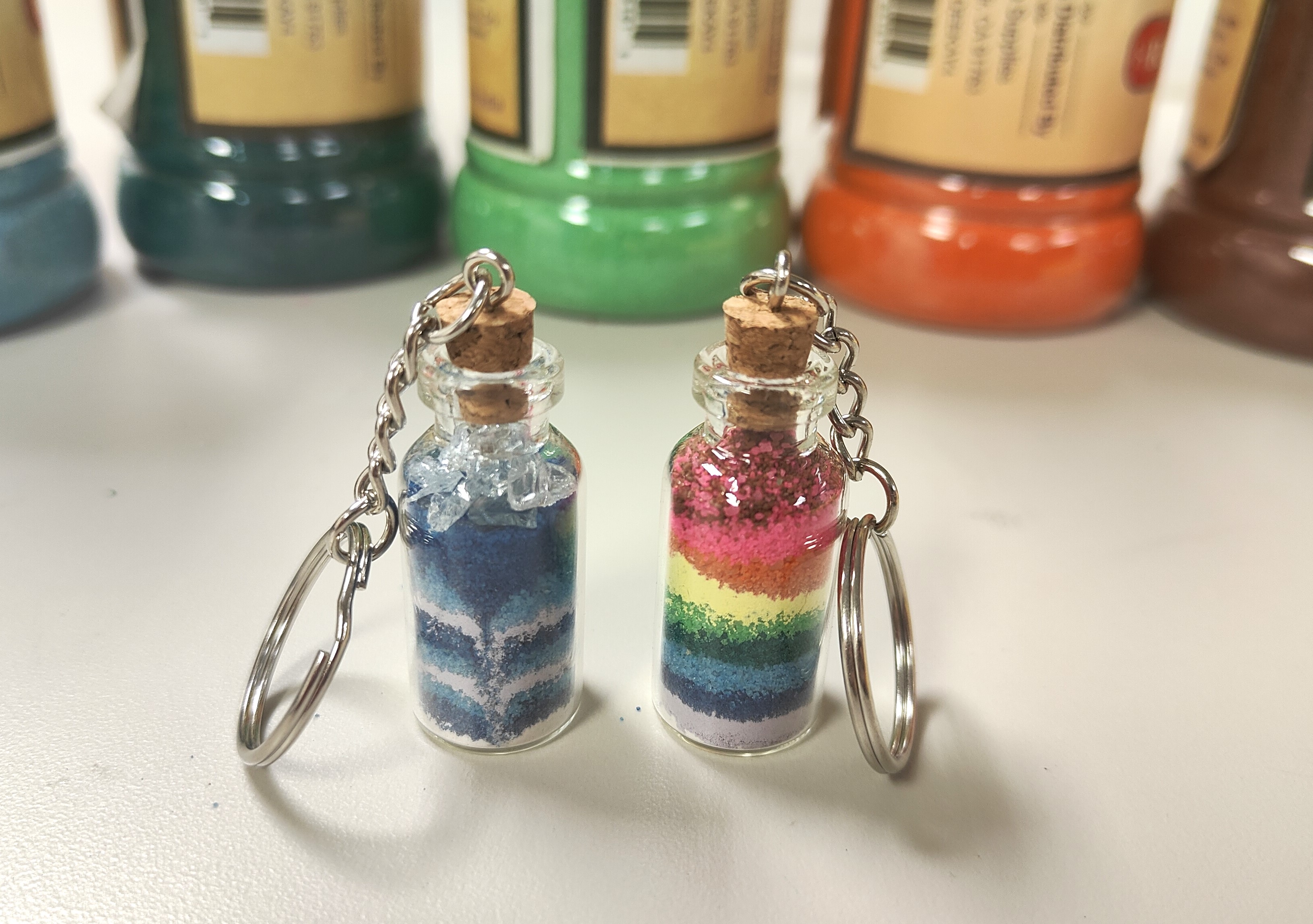 2 mini sand art bottle charms on keychains