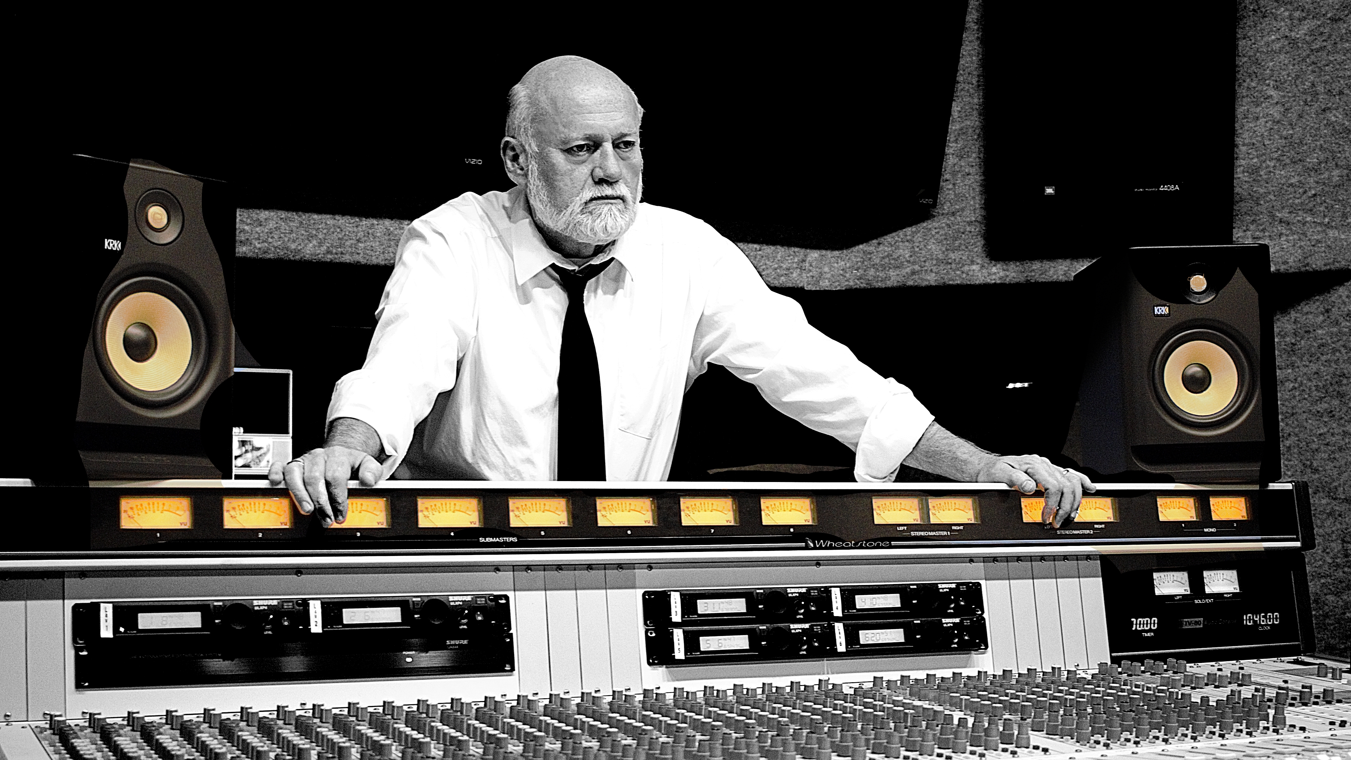 Dr. Alan Campbell standing by a radio soundboard