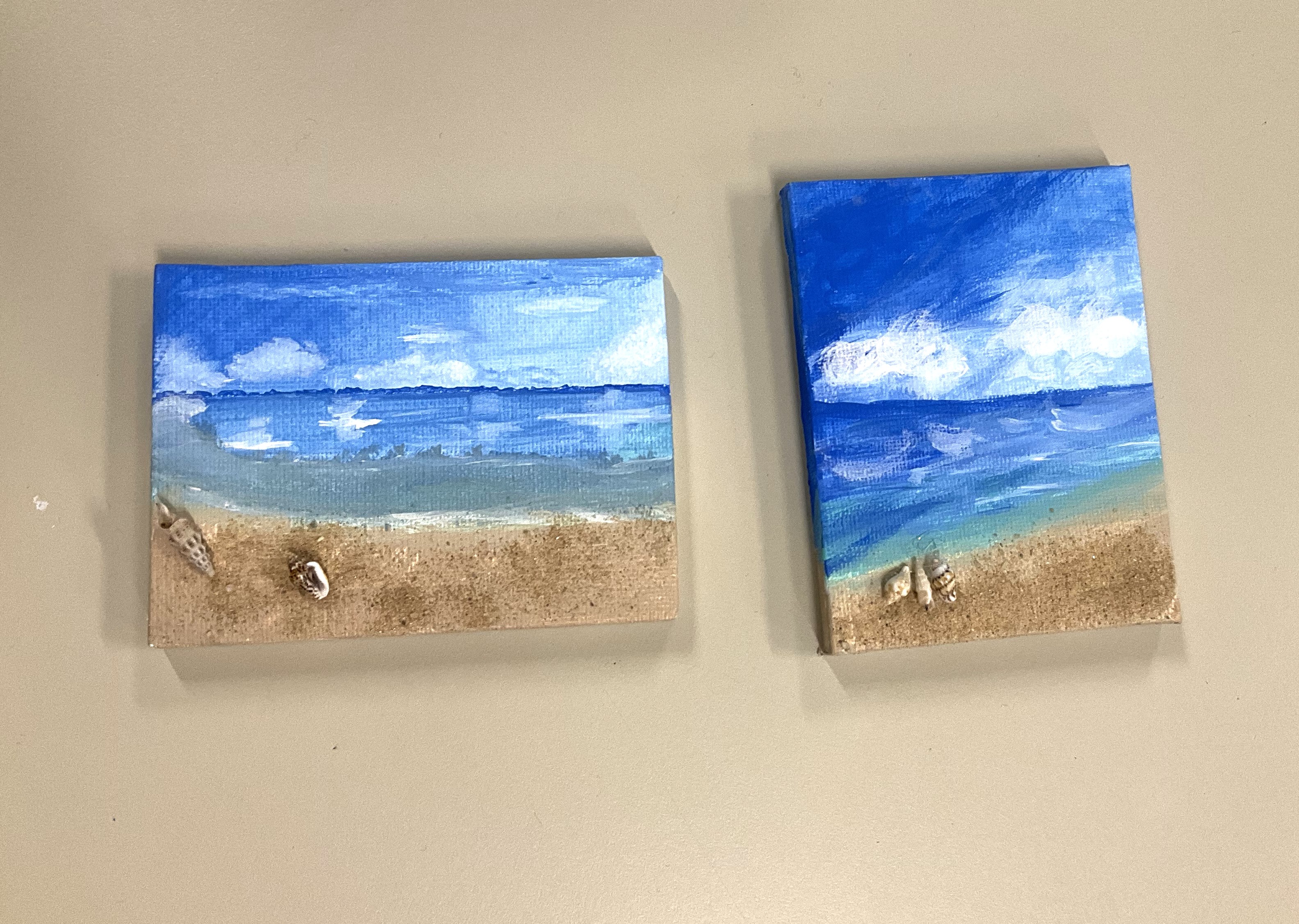 2 small canvasses with a painting of a beach