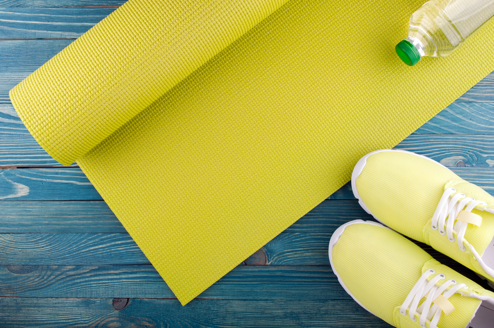 Fitness mat pictured with water bottle and sneakers 