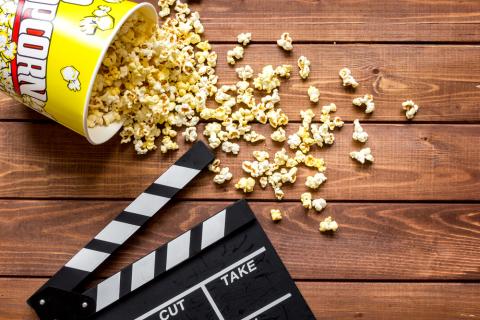 watching movie with popcorn on wooden background