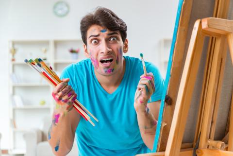 Funny male art next to canvas. Shutterstock.