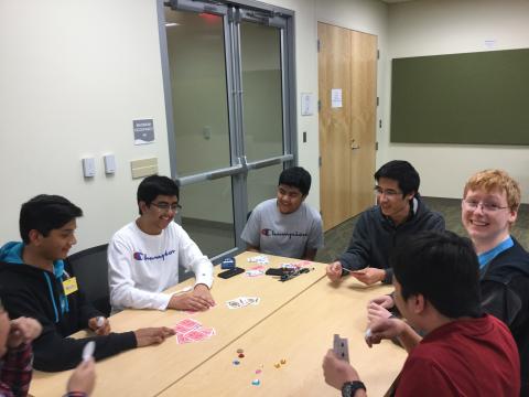Group of teens playing a card game