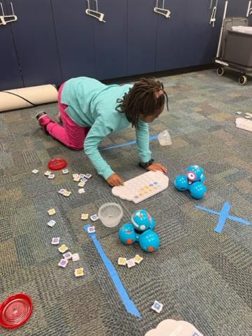 Girl with Dash robot and puzzlets