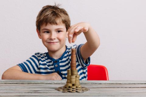 boy stacking coins