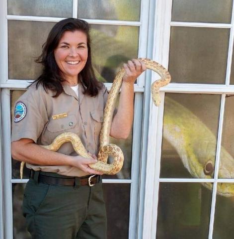 Photo of ranger Rachel H with Lemmy the snake