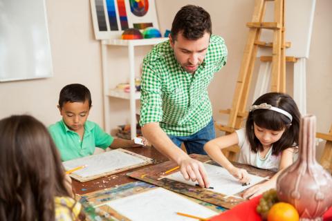 children and teacher in art class