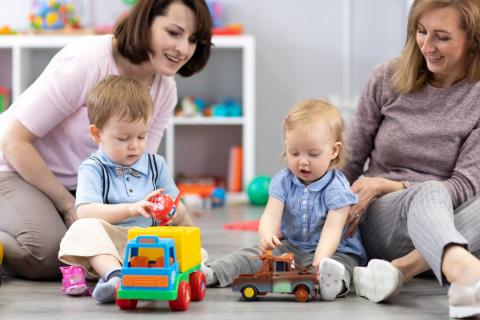 Two mothers watching their babies play