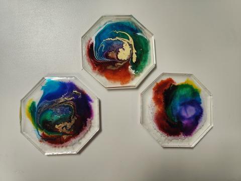 3 hexagon resin coasters with rainbow patterns