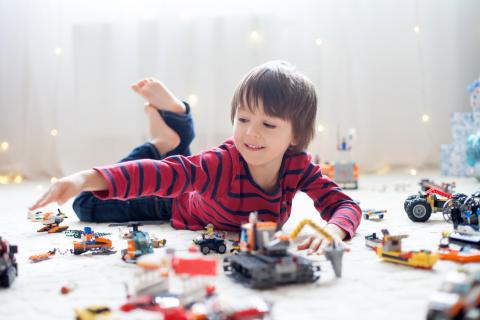 boy on floor with building toys