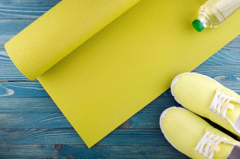 Fitness mat pictured with water bottle and sneakers 