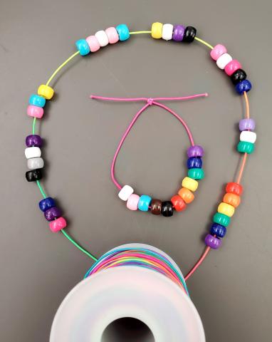 Bead bracelets with colors from LGBTQ+ Pride Flags: including Progress Flag, Bisexual Flag, Asexual Flag, Pansexual Flag, Transgender Flag, Nonbinary Flag, Genderfluid Flag, Genderqueer Flag, Rainbow Flag