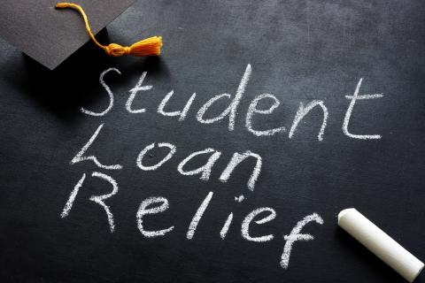 graduation cap with student loan relief written on chalkboard