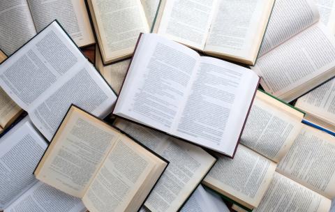 Image of piled, open books