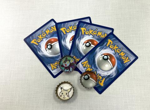 4 Pokémon cards, 3 bottle caps with Pokémon themed images 