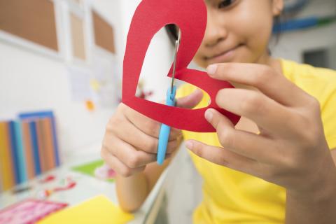 Child cutting heart