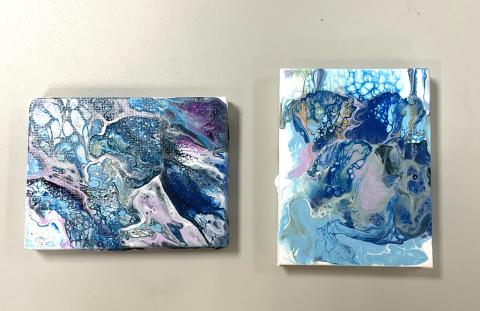 2 canvases with shades of white, blue, purple, gold and silver