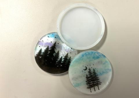 silicone mold, 2 winter resin coasters with black tree silhouettes