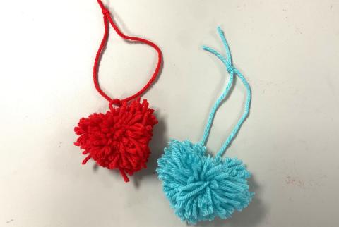 red pom pom heart and teal pom pom heart