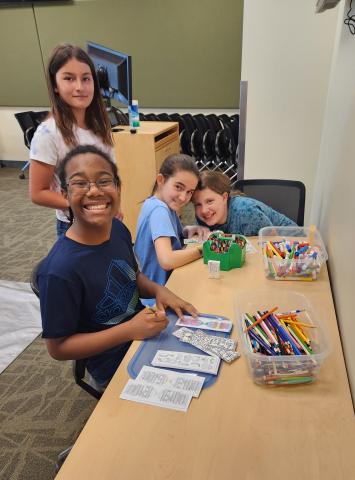 4 teens making bookmarks