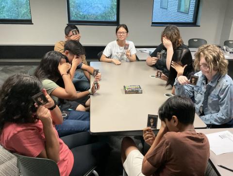 teens with eyes closed except for one with her eyes opened